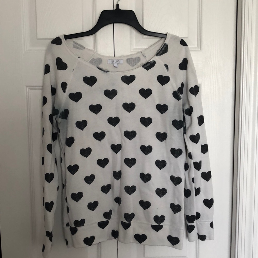 White sweater with black hearts